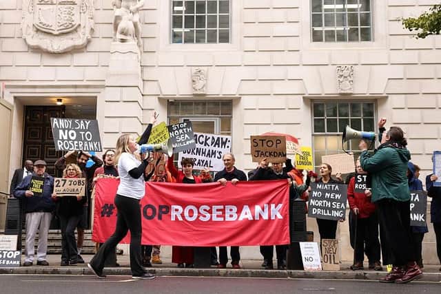 Demonstrators hold anti-Jackdaw and anti-Rosebank placards outside the Department for Energy Security and Net Zero in London yesterday (Picture: Brook Mitchell / AFP via Getty Images)