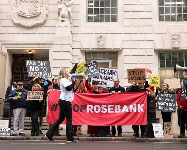 Demonstrators hold anti-Jackdaw and anti-Rosebank placards outside the Department for Energy Security and Net Zero in London yesterday (Picture: Brook Mitchell / AFP via Getty Images)