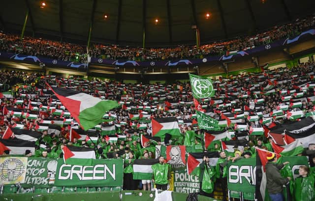 Celtic fans hold up Palestine flags during the UEFA Champions League match against Atletico de Madrid at Celtic Park. (Photo by Rob Casey / SNS Group)