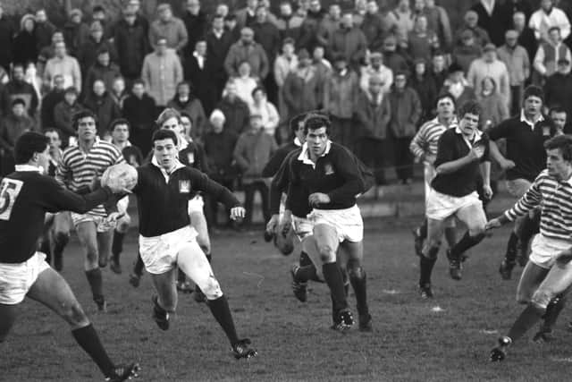 Gavin Hastings receives the ball from brother Scott during Edinburgh's win over the Anglo-Scots. Picture: Denis Straughan/The Scotsman