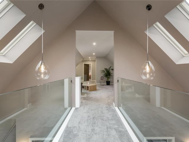Glass-sided walkway from landing to upper sitting room.