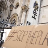 A placard left outside the High Court where the ruling on Rwanda deportation flights is taking place in London. British Foreign Secretary Liz Truss says the first deportation flight to Rwanda will take off in the evening of Tuesday, June 14th, regardless of how many people are on board, as immigration attorneys launch case-by-case appeals on behalf of the migrants scheduled for removal. Photo: AP Photo/Alastair Grant, File.