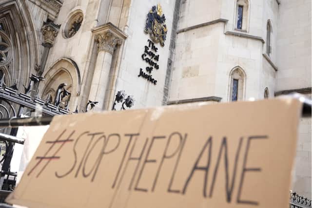A placard left outside the High Court where the ruling on Rwanda deportation flights is taking place in London. British Foreign Secretary Liz Truss says the first deportation flight to Rwanda will take off in the evening of Tuesday, June 14th, regardless of how many people are on board, as immigration attorneys launch case-by-case appeals on behalf of the migrants scheduled for removal. Photo: AP Photo/Alastair Grant, File.
