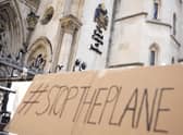 A placard left outside the High Court where the ruling on Rwanda deportation flights is taking place in London. British Foreign Secretary Liz Truss says the first deportation flight to Rwanda will take off in the evening of Tuesday, June 14th, regardless of how many people are on board, as immigration attorneys launch case-by-case appeals on behalf of the migrants scheduled for removal. Photo: AP Photo/Alastair Grant, File.