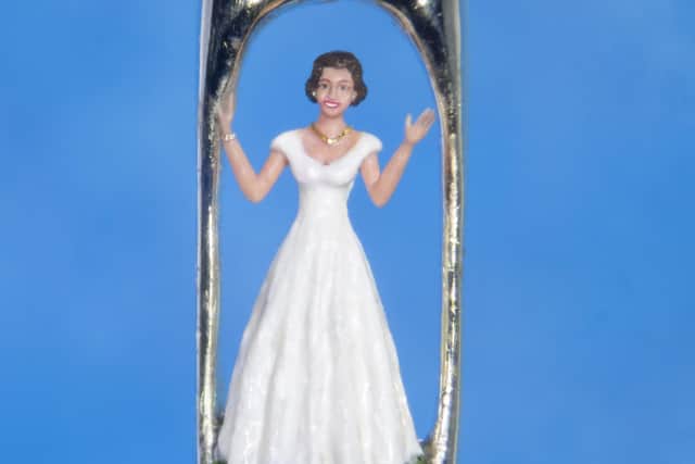 Dr Wigan of a model of Queen ElizabethII as a young woman which fits inside the eye of a needle