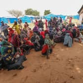 Women who fled the war in Sudan await the distribution of international aid rations at the Ourang refugee camp in eastern Chad last month after hundreds of thousands of refugees fled across Sudan's border.