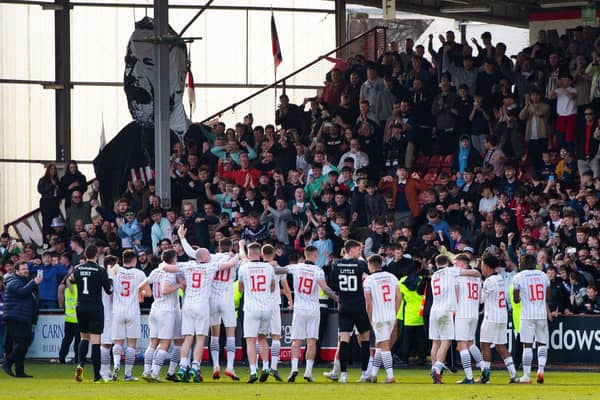 Dunfermline celebrate with their fans as they are crowned League One champions following a 5-0 win over Queen of the South.