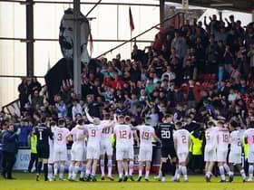 Dunfermline celebrate with their fans as they are crowned League One champions following a 5-0 win over Queen of the South.