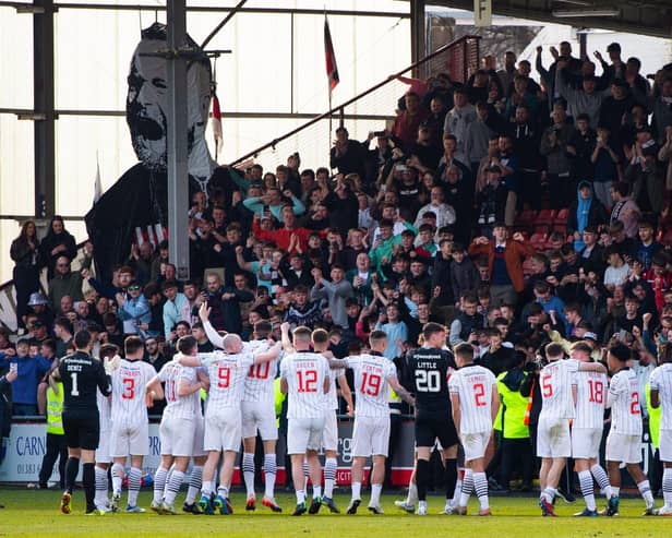 Dunfermline celebrate with their fans as they are crowned League One champions following a 5-0 win over Queen of the South.