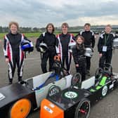 Team GTM young engineers at East Fortune: L-R Rufus Turley, Fergus Dunbar, Harvey Pole, Millie Pole, Edward Cormack, Alexander Brodie with the cars Spyder (L) and Merlin (R)