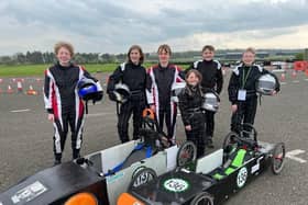 Team GTM young engineers at East Fortune: L-R Rufus Turley, Fergus Dunbar, Harvey Pole, Millie Pole, Edward Cormack, Alexander Brodie with the cars Spyder (L) and Merlin (R)