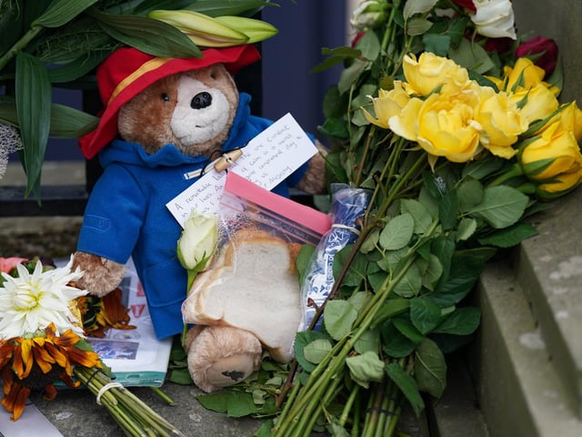 A toy Paddington Bear and a marmalade sandwich, a nod to the Queen's association with the children's book character at the Royal Jubilee, laid outside the Palace of Holyroodhouse in Edinburgh. Queen Elizabeth II's coffin is travelling from Balmoral to Edinburgh, where it will lie at rest at the Palace of Holyroodhouse.