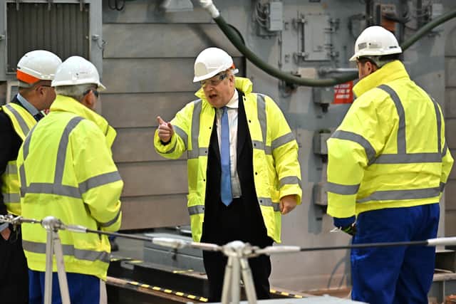 Prime Minister Boris Johnson is shown a vessel undergoing refit for the Ukrainian Navy during a visit to Rosyth Dockyard near Edinburgh, as part of his tour of the UK. Picture date: Monday February 14, 2022.
