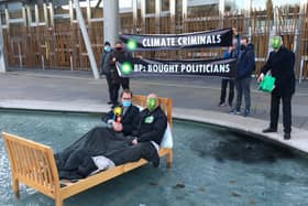 Extinction Rebellion protesters gathered outside the Scottish Parliament, with two activists dressing as an MSP and BP respectively, in order to criticise the 'overly cosy relationship between the company and decision-makers'.