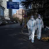 Epidemic control workers wear PPE to prevent the spread of COVID-19 as they walk in an area where communities are in lockdown in China. Protests have broken out around the country, including in Shanghai, where BBC journalist Ed Lawrence was arrested by authorities. Picture: Getty Images