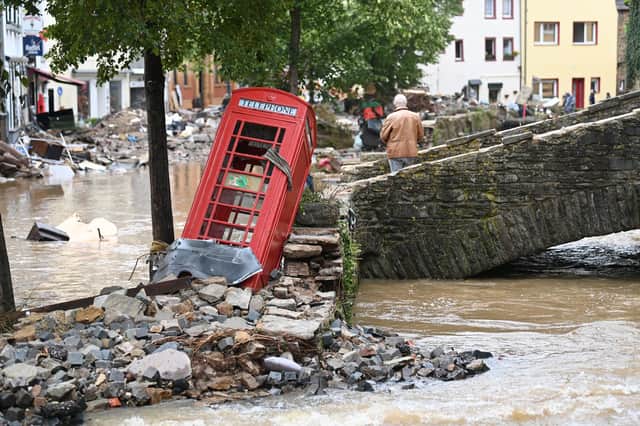 Too close to home? A British red telephone box was toppled after floods hit a pedestrianised area of Bad Muenstereifel, western Germany (Picture: Ina Fassbender/AFP via Getty Images)