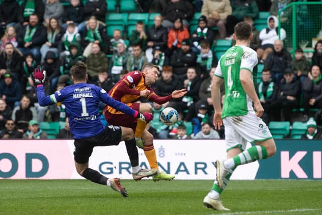 Motherwell's Blair Spittal is brought down in the box by Hibs goalkeeper David Marshall. Photo by Craig Foy / SNS Group