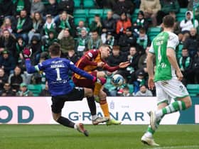 Motherwell's Blair Spittal is brought down in the box by Hibs goalkeeper David Marshall. Photo by Craig Foy / SNS Group