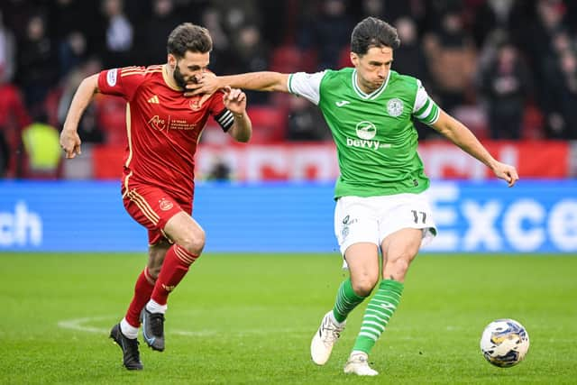 Aberdeen's Graeme Shinnie hunts down Hibs' Joe Newell.