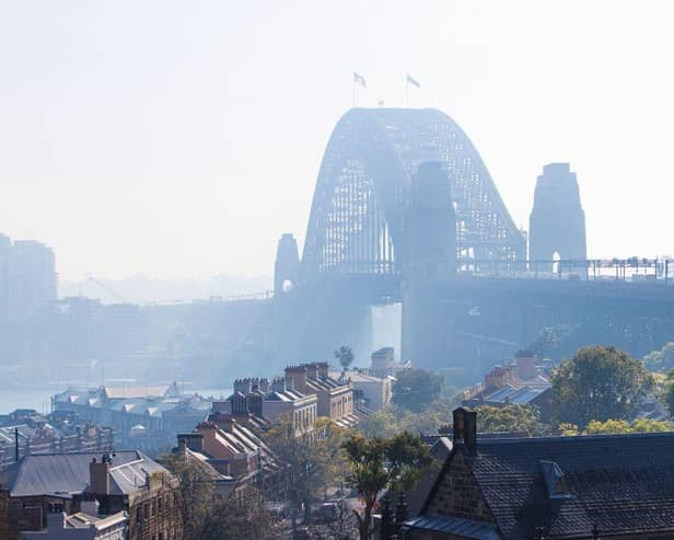 The Sydney Harbour Bridge is seen shrouded by smoke in Sydney after a ring of controlled blazes burned on the city's fringes in preparation for the looming bushfire season.