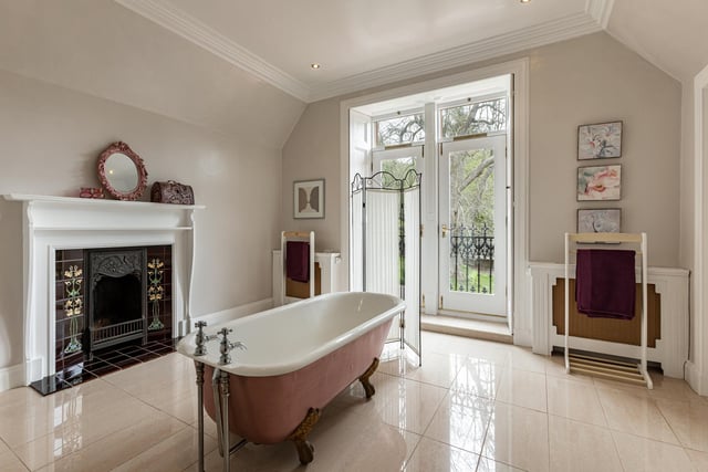 Interior: Its lounge and sitting room benefit from large bay windows, and there is a kitchen, dining room and rear conservatory. Five bedrooms are shared between levels two and three, the master boasting an ensuite bathroom and dressing area.