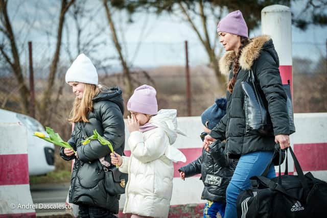 Ukrainian families arriving were handed flowers by Romanian volunteers at the border.
Picture: Andrei Dascalescu