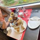 Pam Aldred prepares to enjoy LNER's luxury afternoon tea as the country whizzes by at 125mph