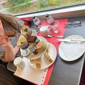 Pam Aldred prepares to enjoy LNER's luxury afternoon tea as the country whizzes by at 125mph