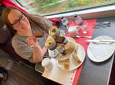 Pam Aldred prepares to enjoy LNER's luxury afternoon tea as the country whizzes by at 125mph