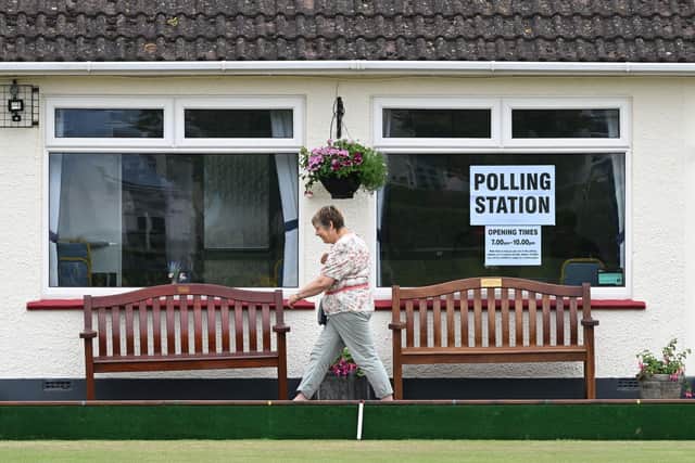 A voter leaves a polling station in Seaton in East Devon as Tiverton and Honiton held a by-election on June 23, 2022 (Photo by JUSTIN TALLIS/AFP via Getty Images)