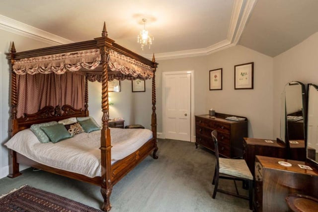 One of the 13 bedrooms, many of which have an array or original features including ornate cornicing and plasterwork, open fires and tall ceilings.