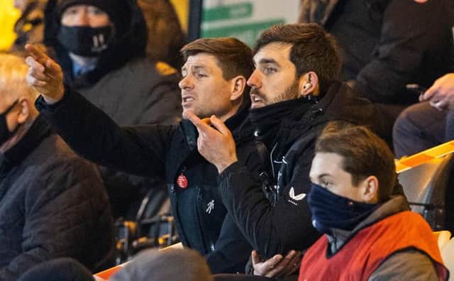 Rangers manager Steven Gerrard, seated beside analyst Scott Mason, watches from the stand after being sent off by referee John Beaton at half-time of his team's 1-0 win at Livingston. (Photo by Alan Harvey / SNS Group)