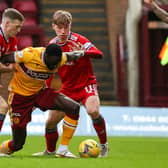 Motherwell's Bevis Mugabi in action alongside Lewis Ferguson and Aberdeen's Adam Montgomerey.