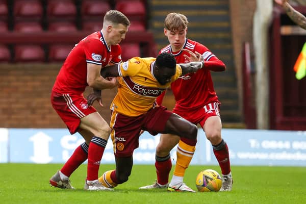 Motherwell's Bevis Mugabi in action alongside Lewis Ferguson and Aberdeen's Adam Montgomerey.