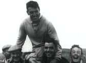 Fans carry golfing legend Stuart Murray off the course after a famous victory