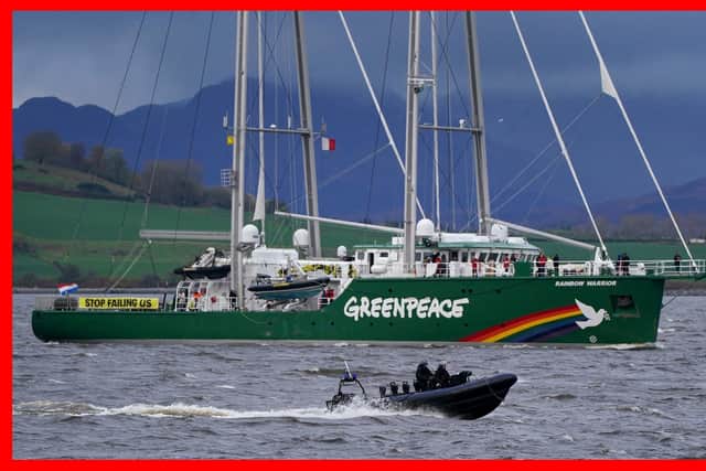 The Greenpeace ship Rainbow Warrior makes its way up the River Clyde.