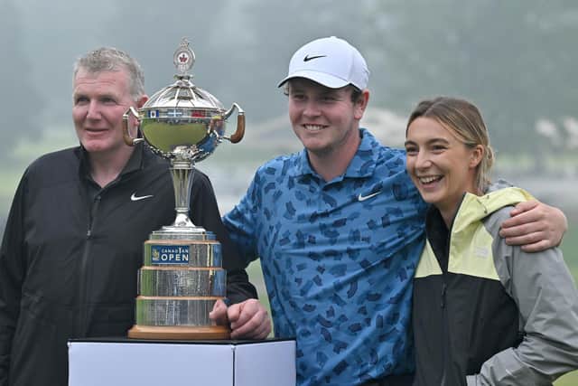Bob MacIntyre poses with the trophy alongside his dad and caddie Dougie and girlfriend Shannon Hartley after winning the RBC Canadian Open at Hamilton Golf & Country Club on June 02, 2024 in Hamilton, Ontario, last weekend. Picture: Minas Panagiotakis/Getty Images.