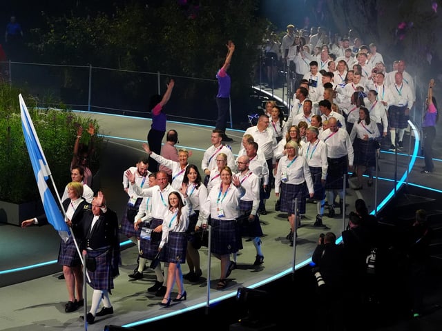 Alex Marshall, flag bearer of Scotland alongside Sarah Adlington, baton bearer leads their delegation