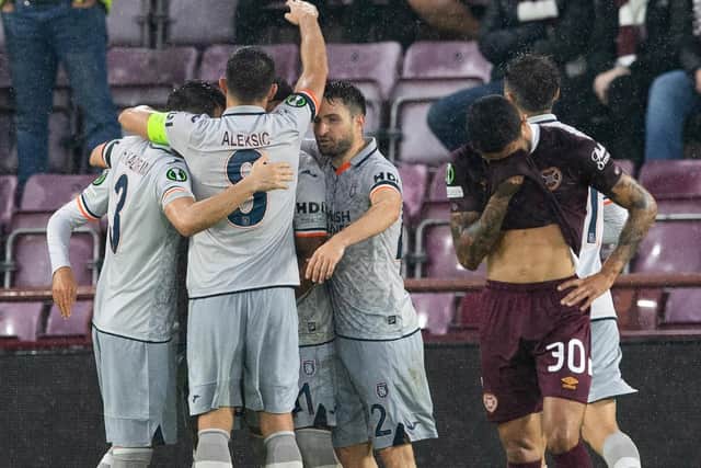 Hearts winger Josh Ginnelly looks dejected as the Isatnbul squad celebrate making it 4-0.  (Photo by Paul Devlin / SNS Group)