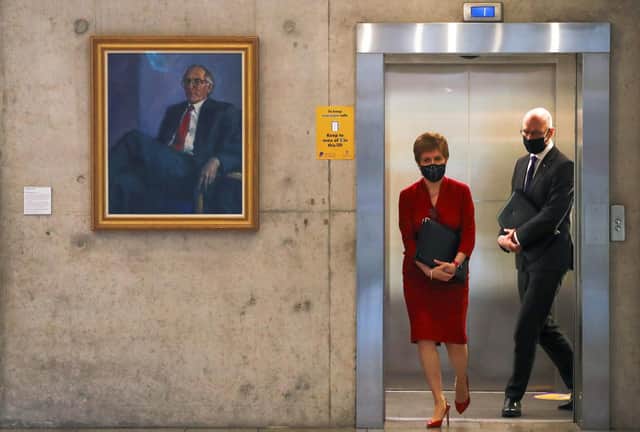 Nicola Sturgeon, exiting a lift in the Scottish Parliament, has laid out a skeleton route map out of Covid lockdown.