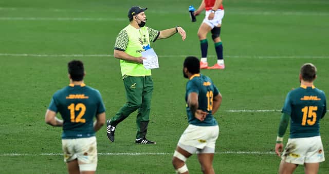 Rassie Erasmus, South Africa's director of rugby, acts as a water carrier as he issues instructions to the Springboks during the first Test against the British & Irish Lions. David Rogers/Getty Images