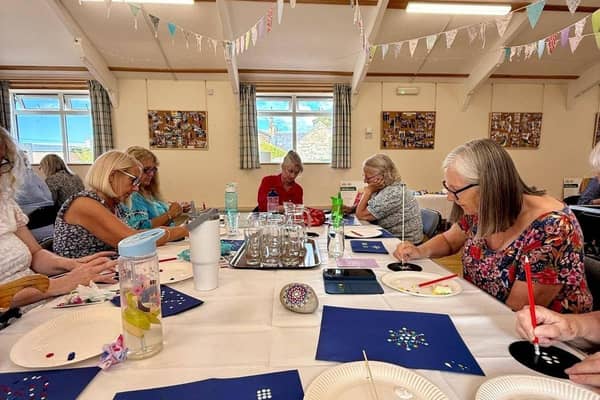 A group of participants working on their painting