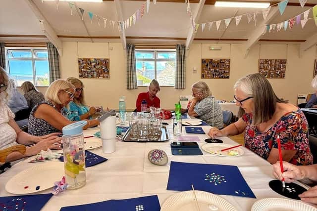 A group of participants working on their painting