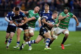 Bath's Finn Russell tries to evade the Leicester defence.