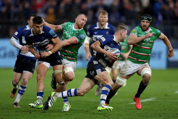 Bath's Finn Russell tries to evade the Leicester defence.