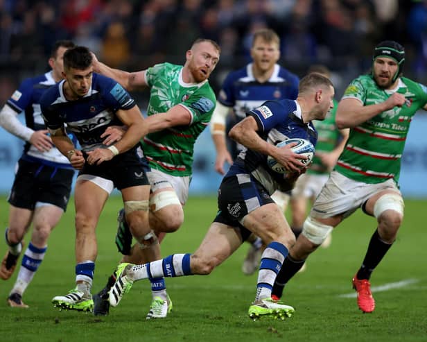 Bath's Finn Russell tries to evade the Leicester defence.