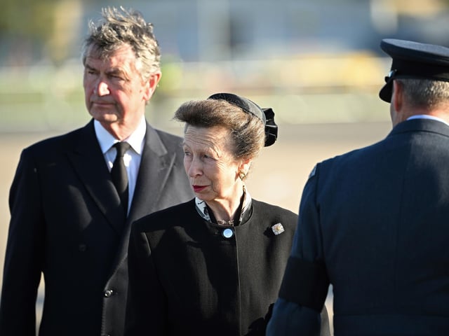 The Princess Royal and Vice Admiral Sir Tim Laurence watch as the coffin of Queen Elizabeth II is carried aboard an RAF aircraft on its journey from Edinburgh to Buckingham Palace, London, where it will lie at rest.