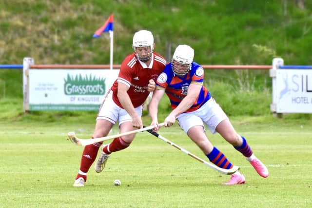 Kinlochshiel's Mark MacDonald (left) and Kingussie's Roddy Young battle for possession. Pic: Fiona Young.