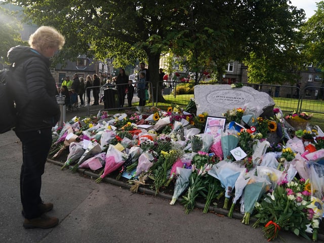 Pausing to pay tribute in Ballater this morning (Pic: PA/Andrew Milligan)