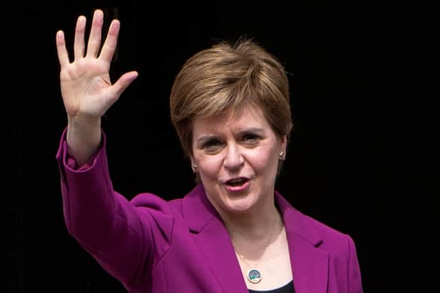 Nicola Sturgeon waves as she returns to Bute House on Sunday